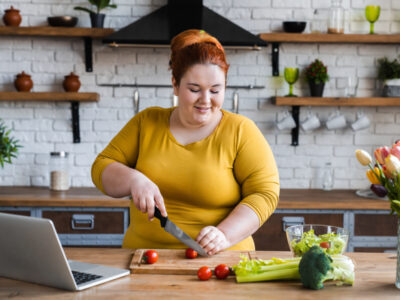 Plus size , fat caucasian woman learning to make salad and healthy food from social media,Social distancing, stay at home concept